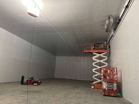 DCW large walk-in cooler under construction with finished insulated metal panel walls